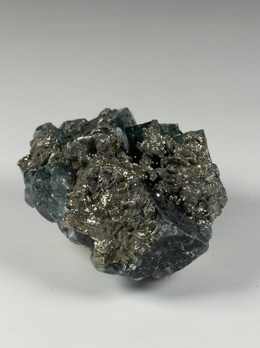 Pyrite on Fluorite