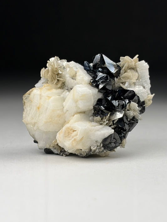 Cassiterite w/ Microcline on Muscovite